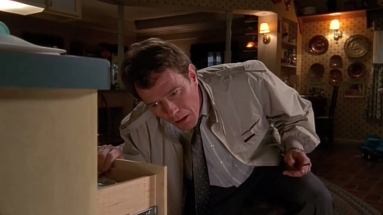 Hal from Malcolm in the Middle, mid-task, surrounded by half-disassembled household projects.